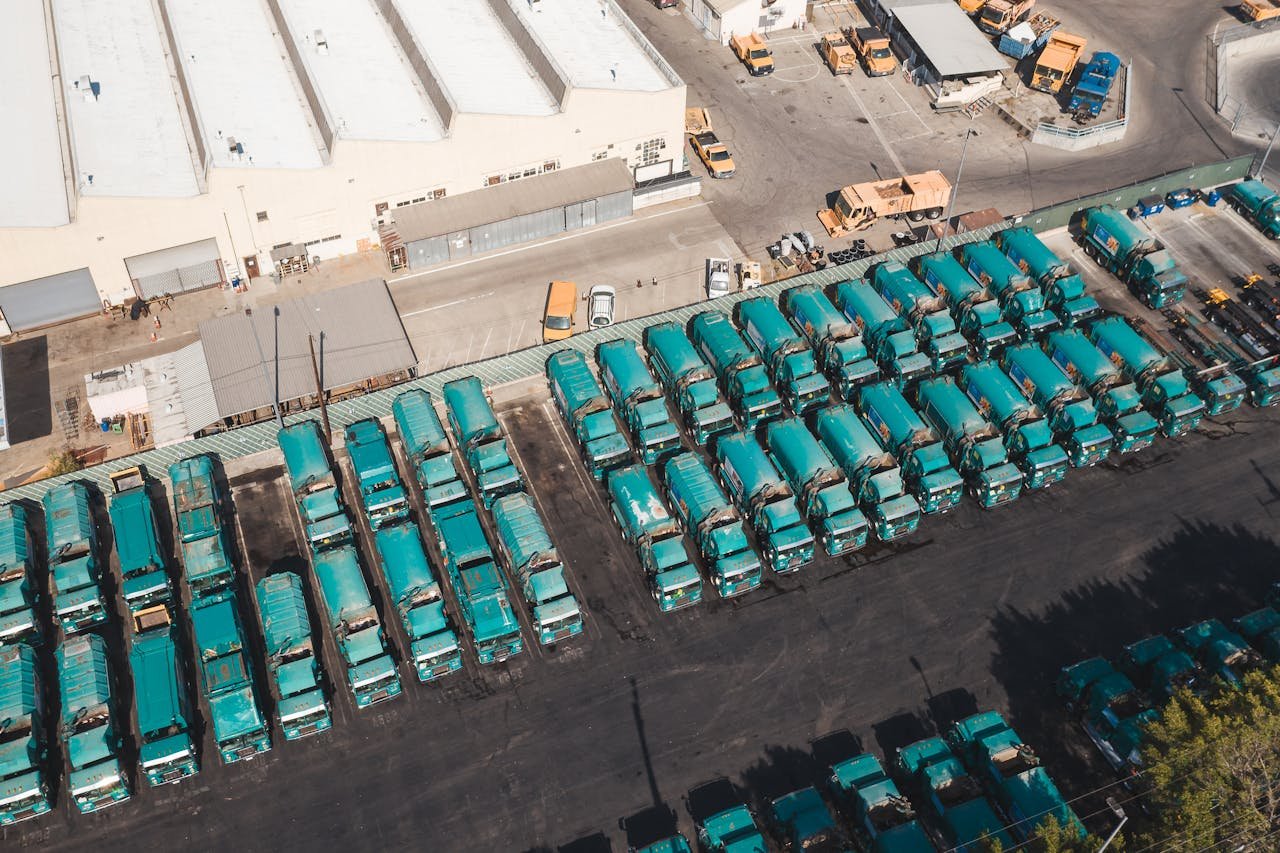 Aerial shot of trucks parked in an industrial area showcasing logistics and transportation.